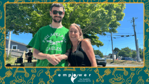 Two Empower N L members smile for the camera at our Annual Members' Barbecue. The Empower N L logo is centered at the bottom.
