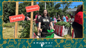 Empower N L member Steph stands in front of the entrance to our back yard carnival at the Annual Members' Barbecue. The Empower N L logo is centered at the bottom.
