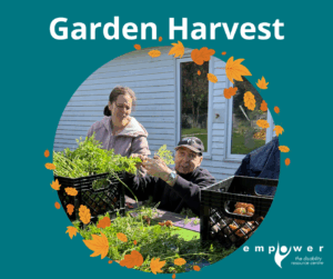 Empower N L members work at a picnic table sorting the results of their Garden Harvest. The Empower N L logo is in the lower right corner.